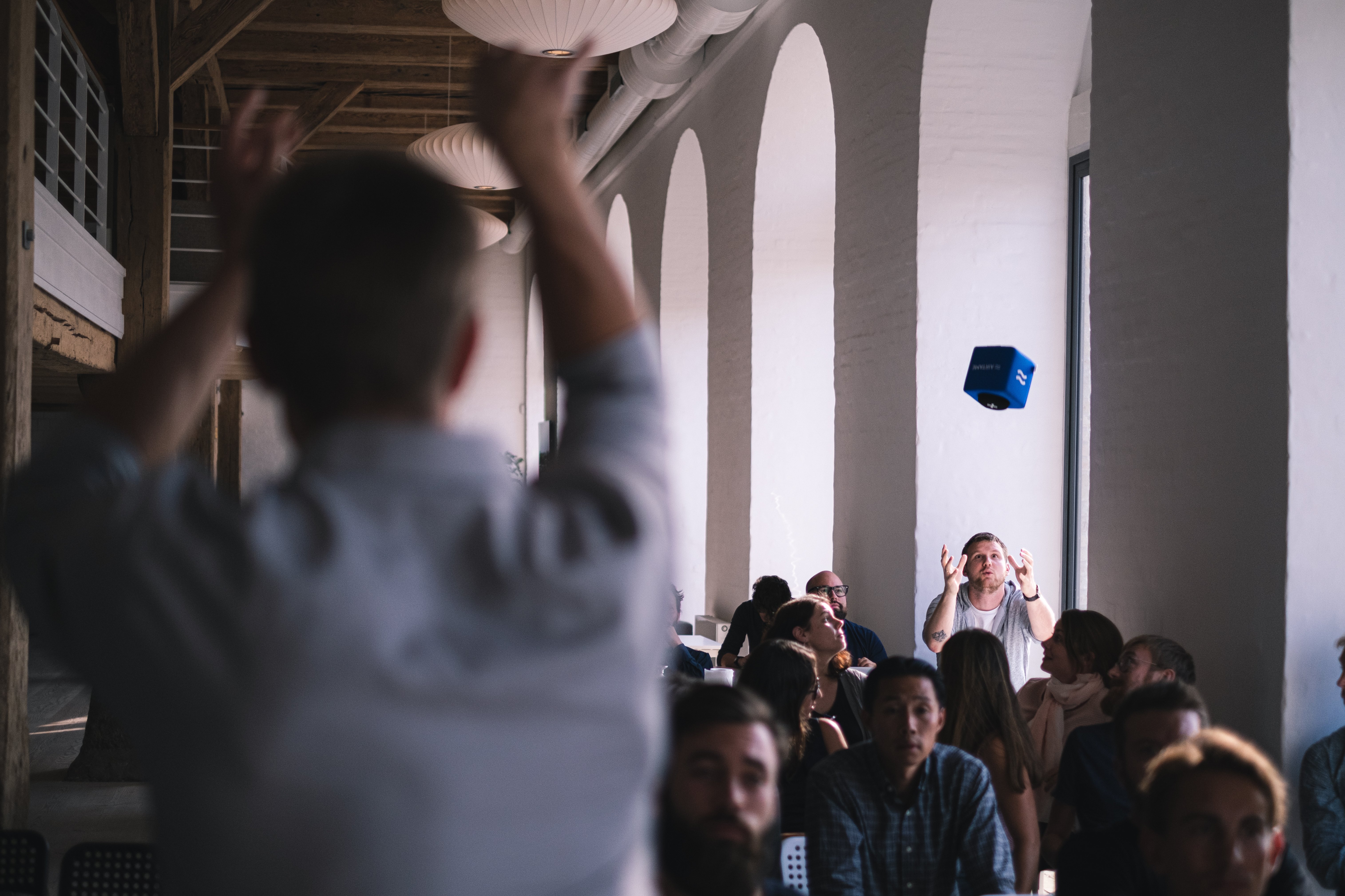 Audience engaged with throwable microphone in conference venue