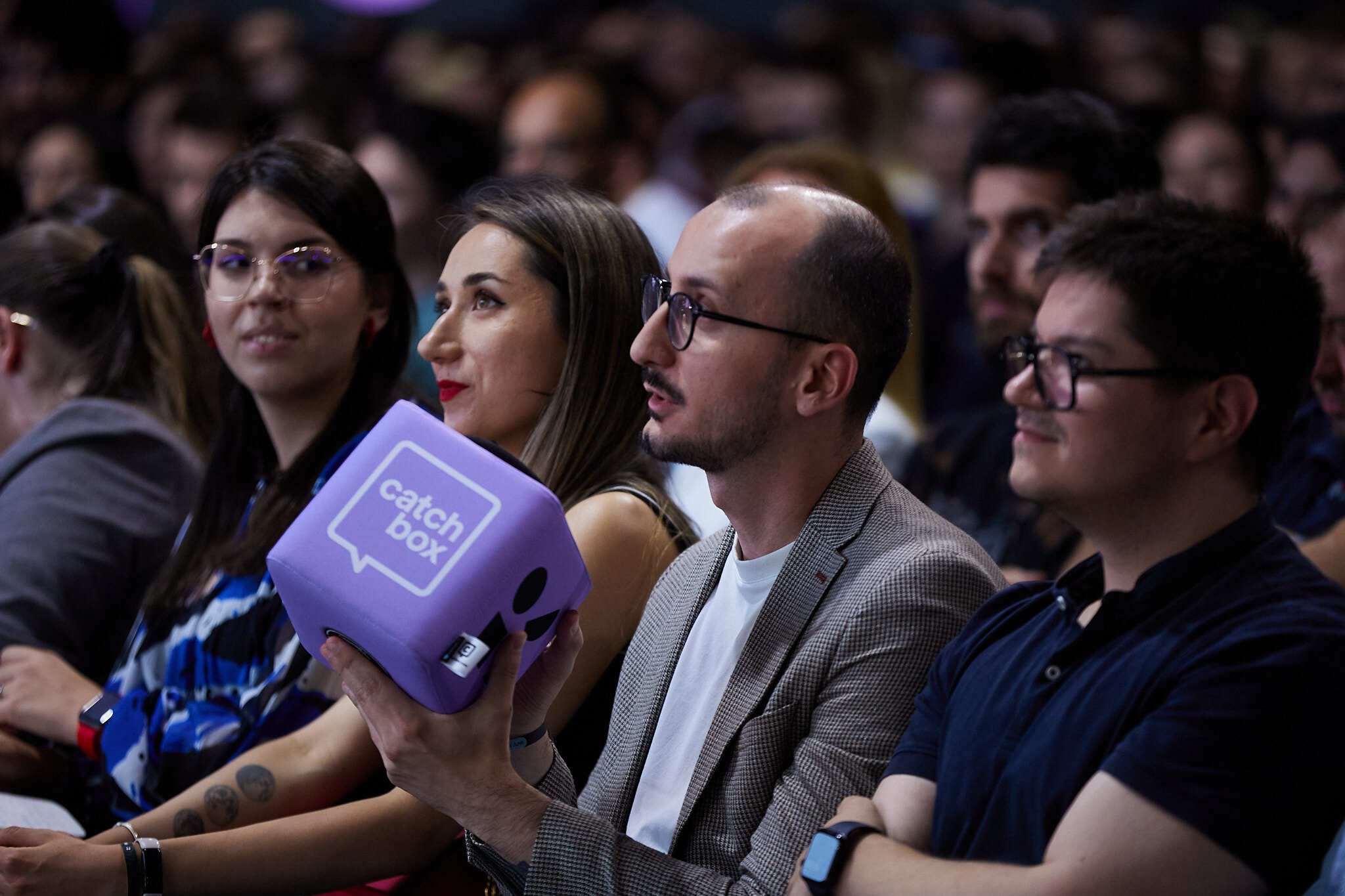 Purple branded throwable microphone in audience