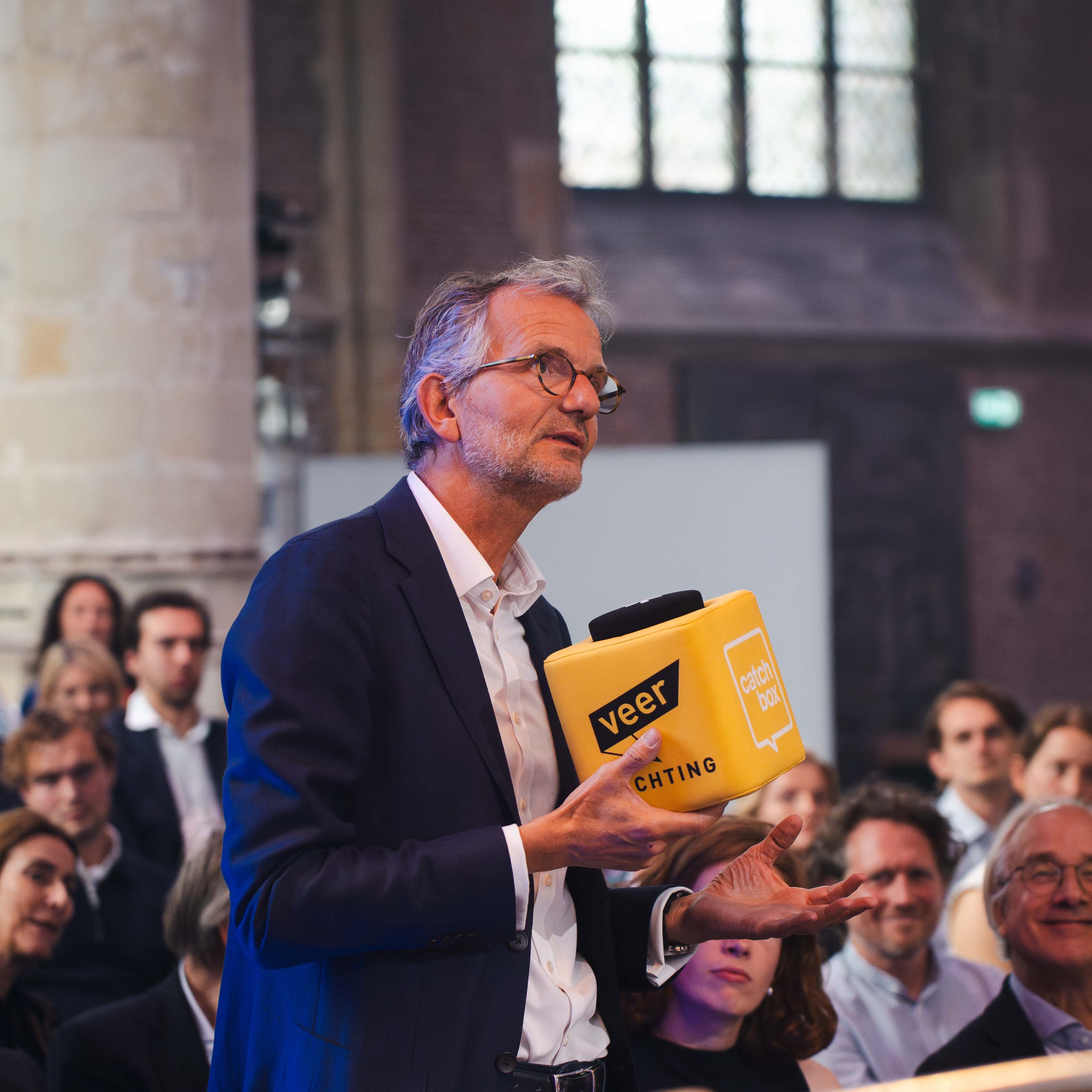 Audience listening to question that is amplified with throwable microphone